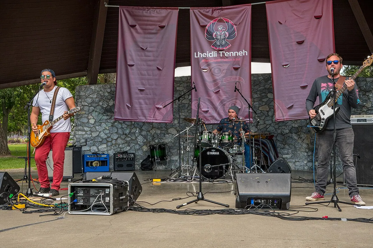 A band plays under the Lheidli T'enneh Memorial Park pavilion, with Lheidli T'enneh banners behind them