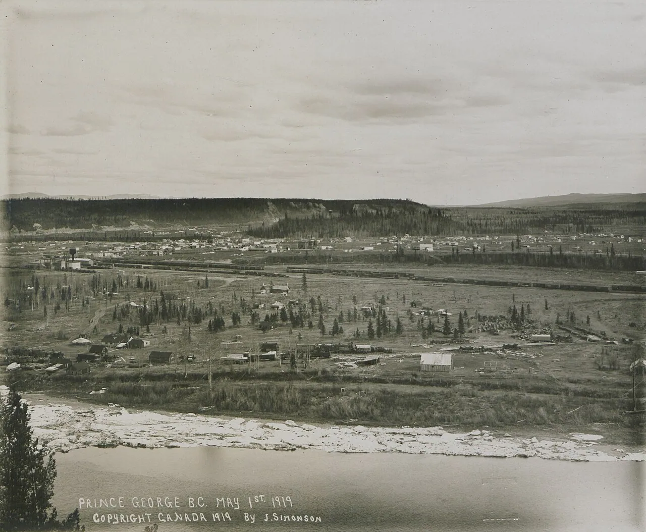 Black and white photograph of the young city of Prince George in May 1919, with low wooden buildings and cleared land