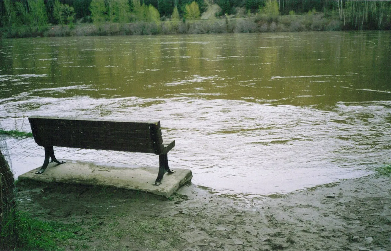 Floodwater from the Nechako River covering the grass and a bench at Paddlewheel Park in Prince George in May 2007