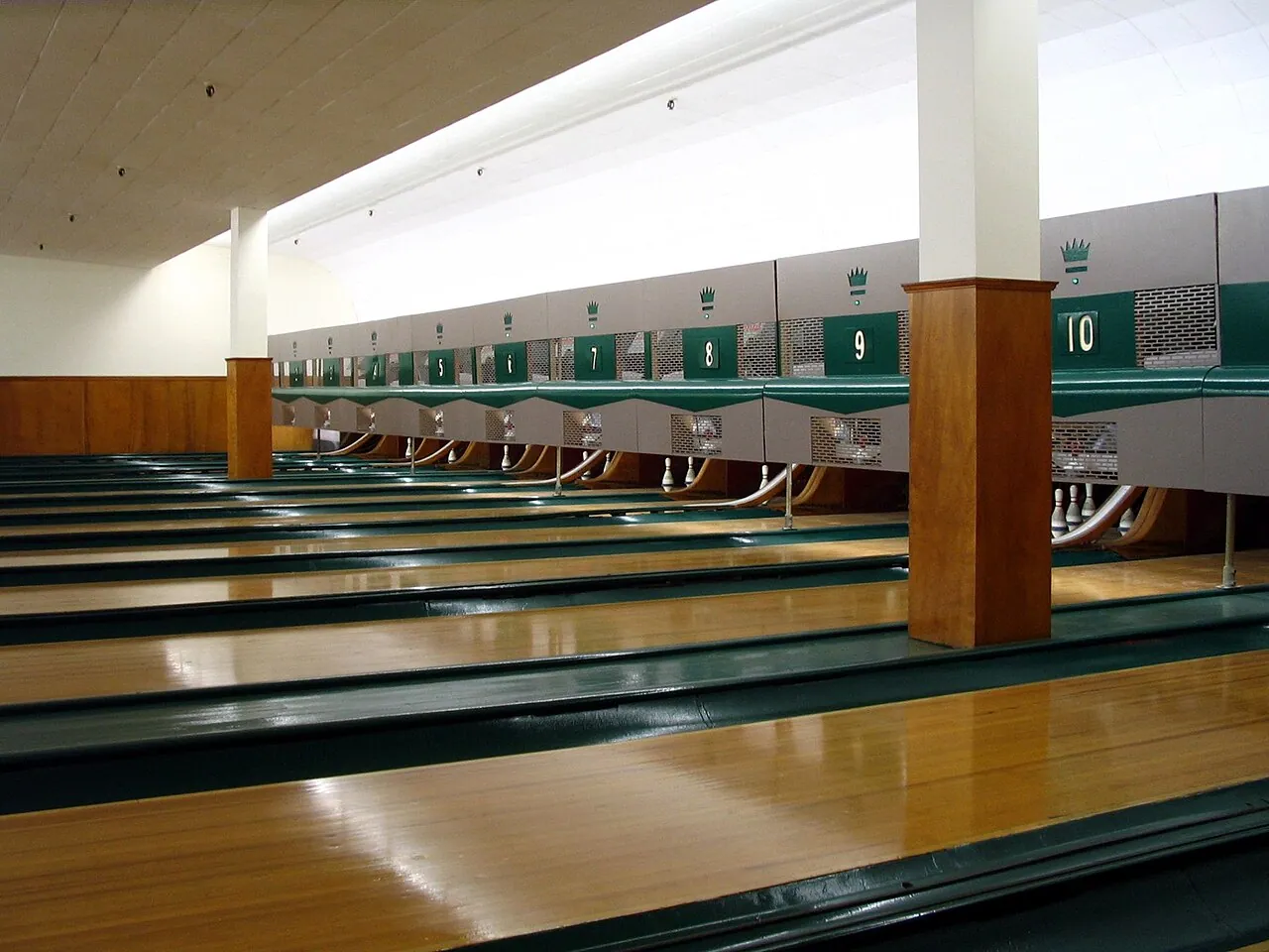A row of empty 5-pin bowling lanes