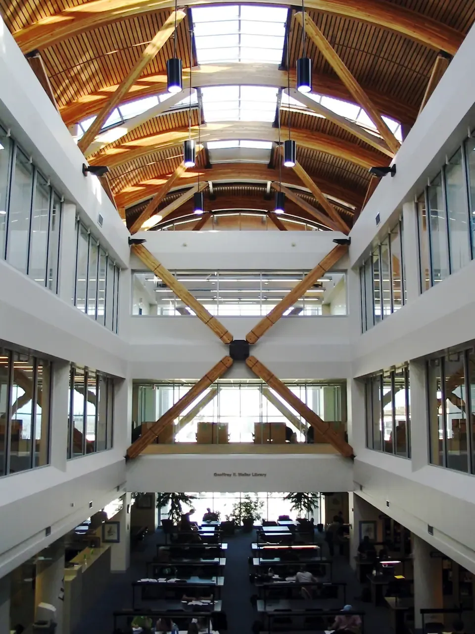 Inside the Geoffrey R. Weller Library at UNBC, with wooden roof beams over an open atrium