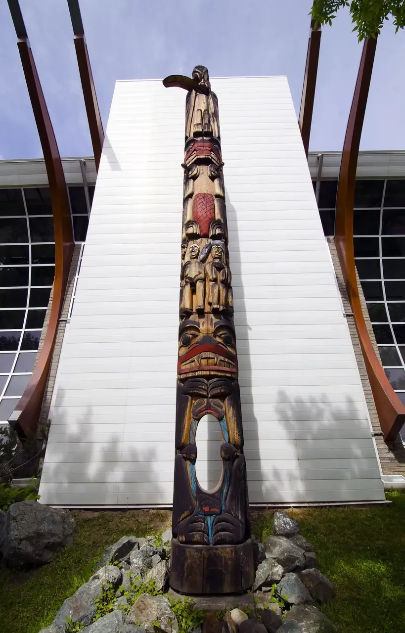 The carved Millennium Unity Pole standing outside Two Rivers Gallery